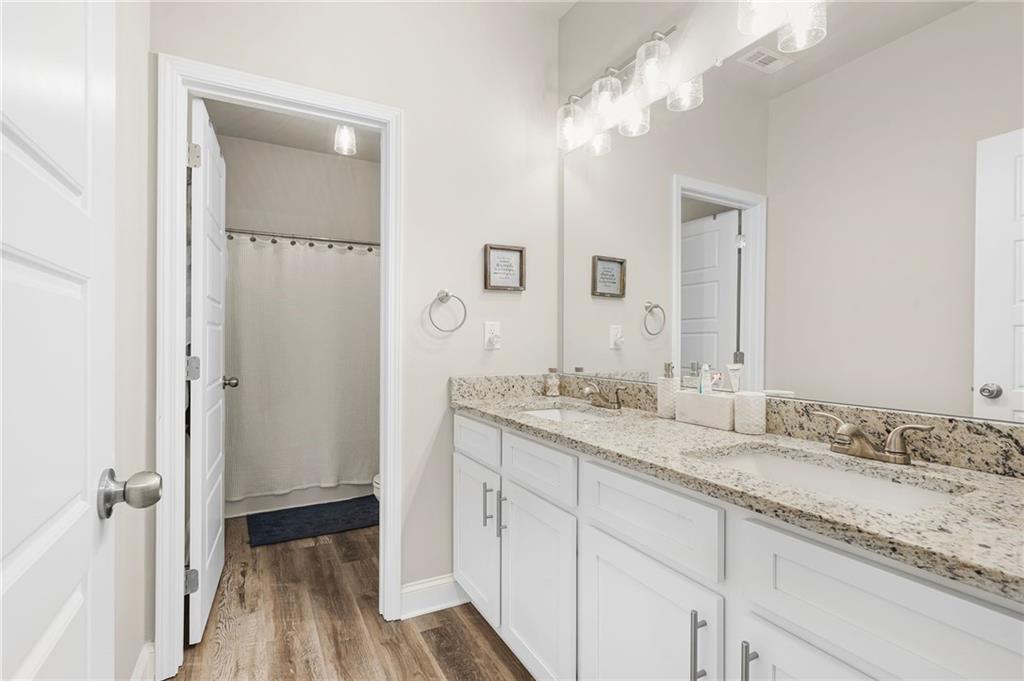 2326 Britt Street Grayson, GA 30017 - Photo 43 of 53 a bathroom with a granite countertop sink and a mirror