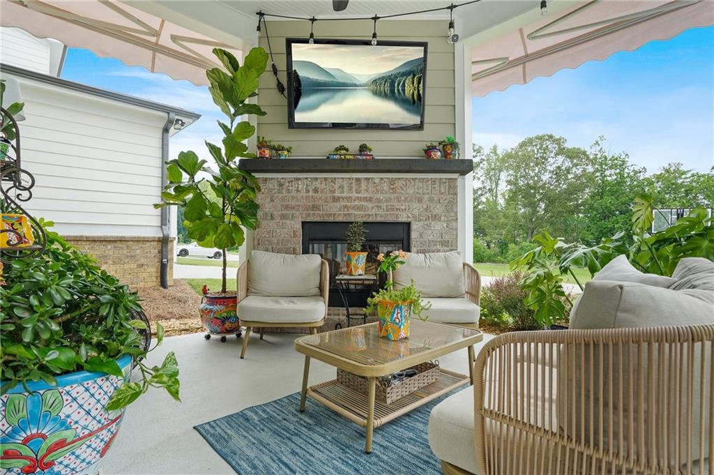 2326 Britt Street Grayson, GA 30017 - Photo 50 of 53 a view of a patio with couches table and chairs with potted plants