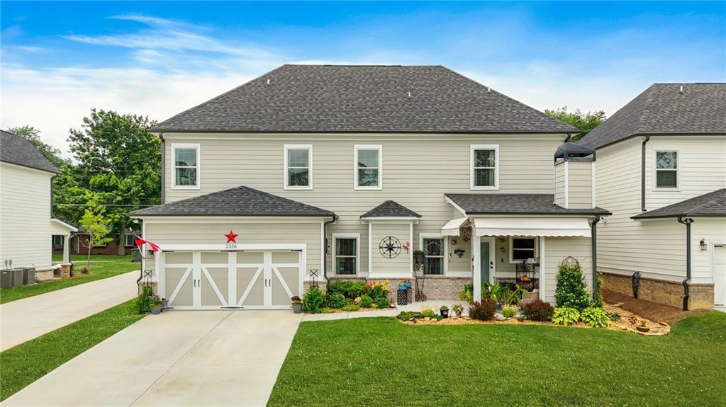 2326 Britt Street Grayson, GA 30017 - Photo 51 of 53 a front view of a house with a yard table and chairs