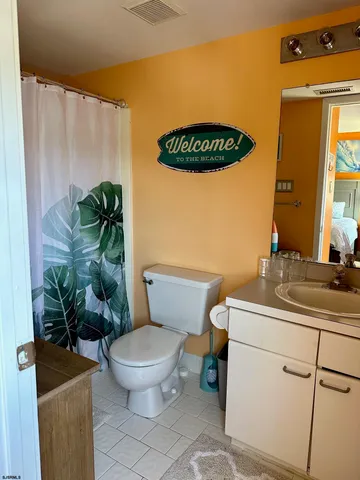 a bathroom with a toilet a sink and a mirror