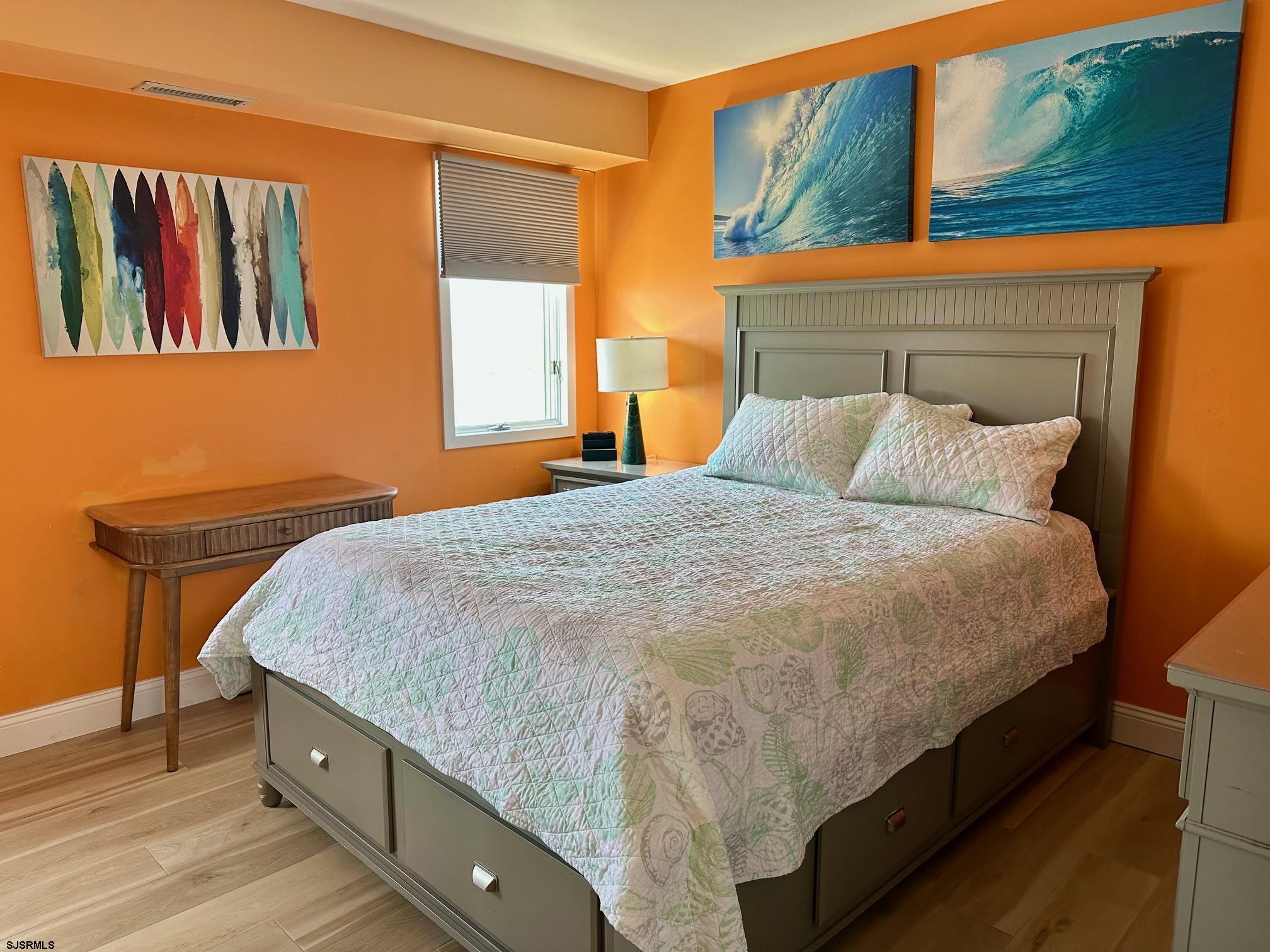 305 4th Street South, Unit 305 Brigantine, NJ 08203 - Photo 23 of 45 a bed sitting in a bedroom next to a window