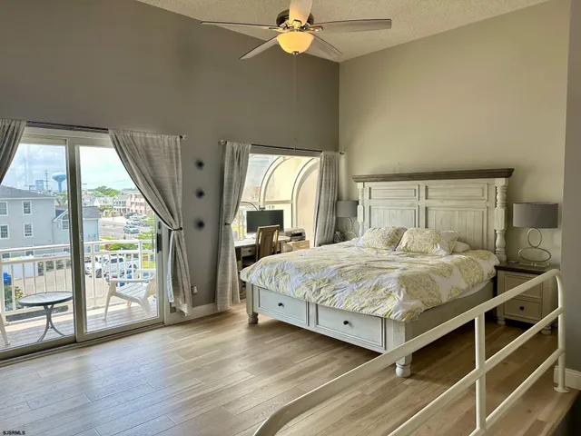 a bedroom with a large bed and a chandelier