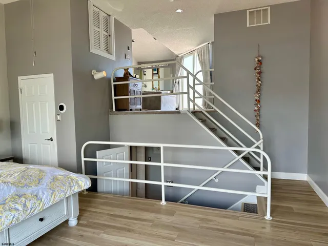 a view of room with wooden floor and staircase