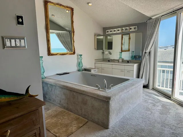 a living room with stainless steel appliances granite countertop furniture and a mirror