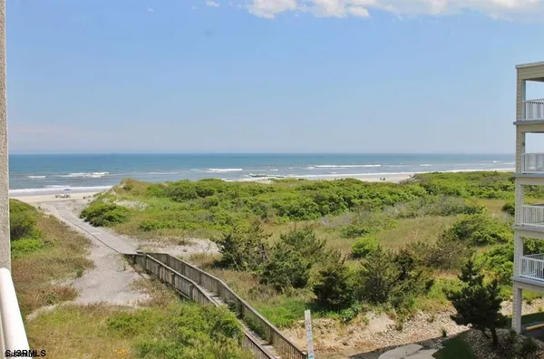 a view of a field with an ocean view