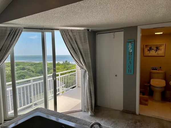 a view of a field with an ocean