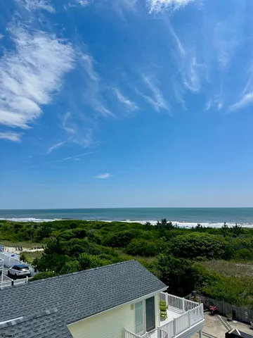 a view of a balcony with floor to ceiling window with wooden fence
