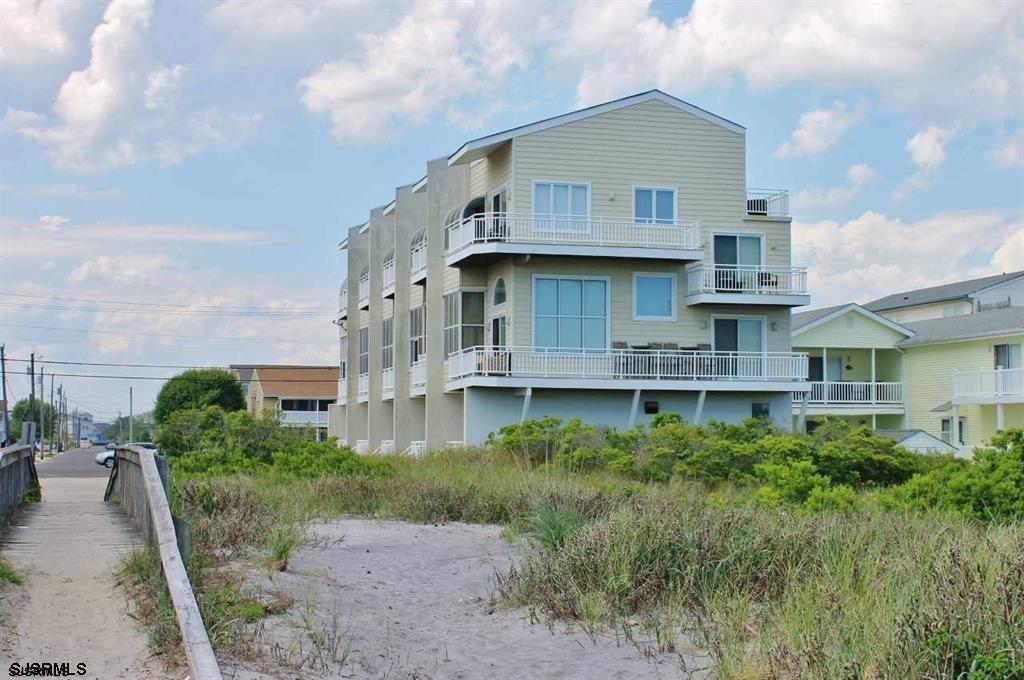 305 4th Street South, Unit 305 Brigantine, NJ 08203 - Photo 4 of 45 a front view of a house with a garden