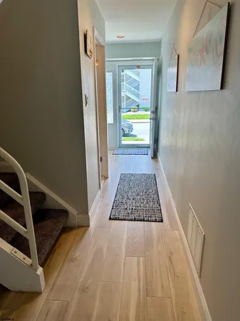 a view of an entryway with wooden floor