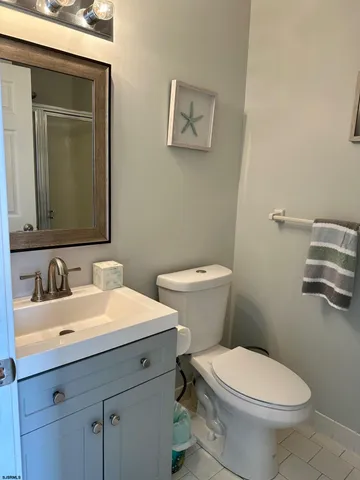 a bathroom with a toilet a sink and mirror