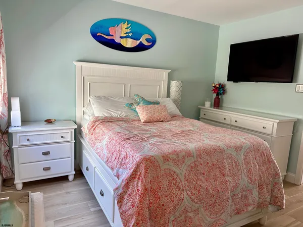 a bedroom with a bed and a flat screen tv