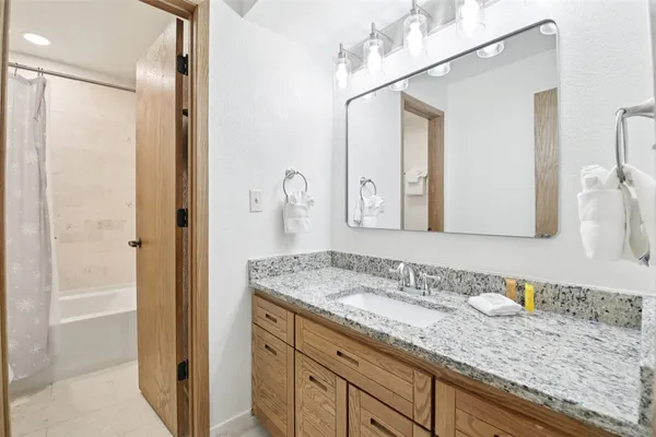 a bathroom with a granite countertop sink mirror and double