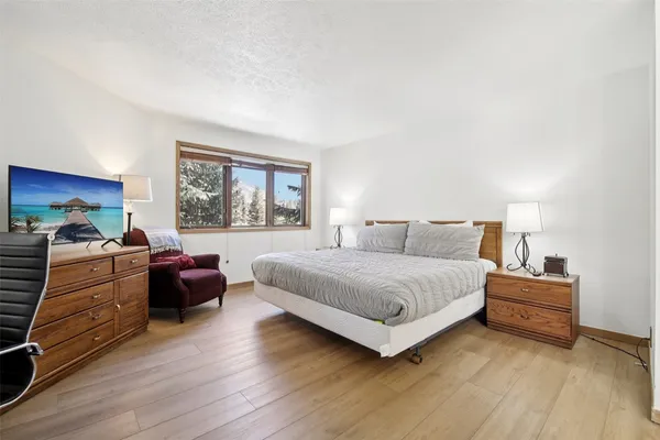 a bedroom with a bed and a large window