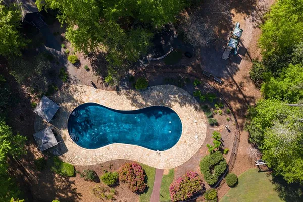 an aerial view of a swimming pool and outdoor space