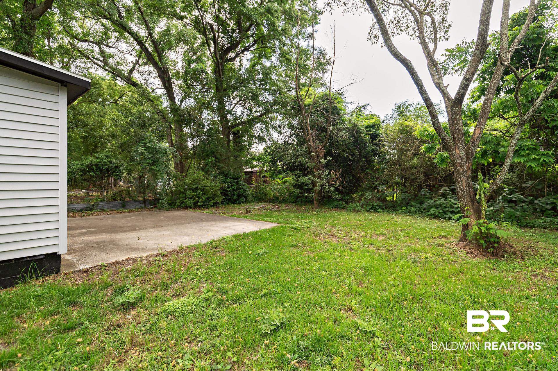 1869 Mott Drive West Mobile, AL 36617 - Photo 32 of 34 View of yard featuring a patio area