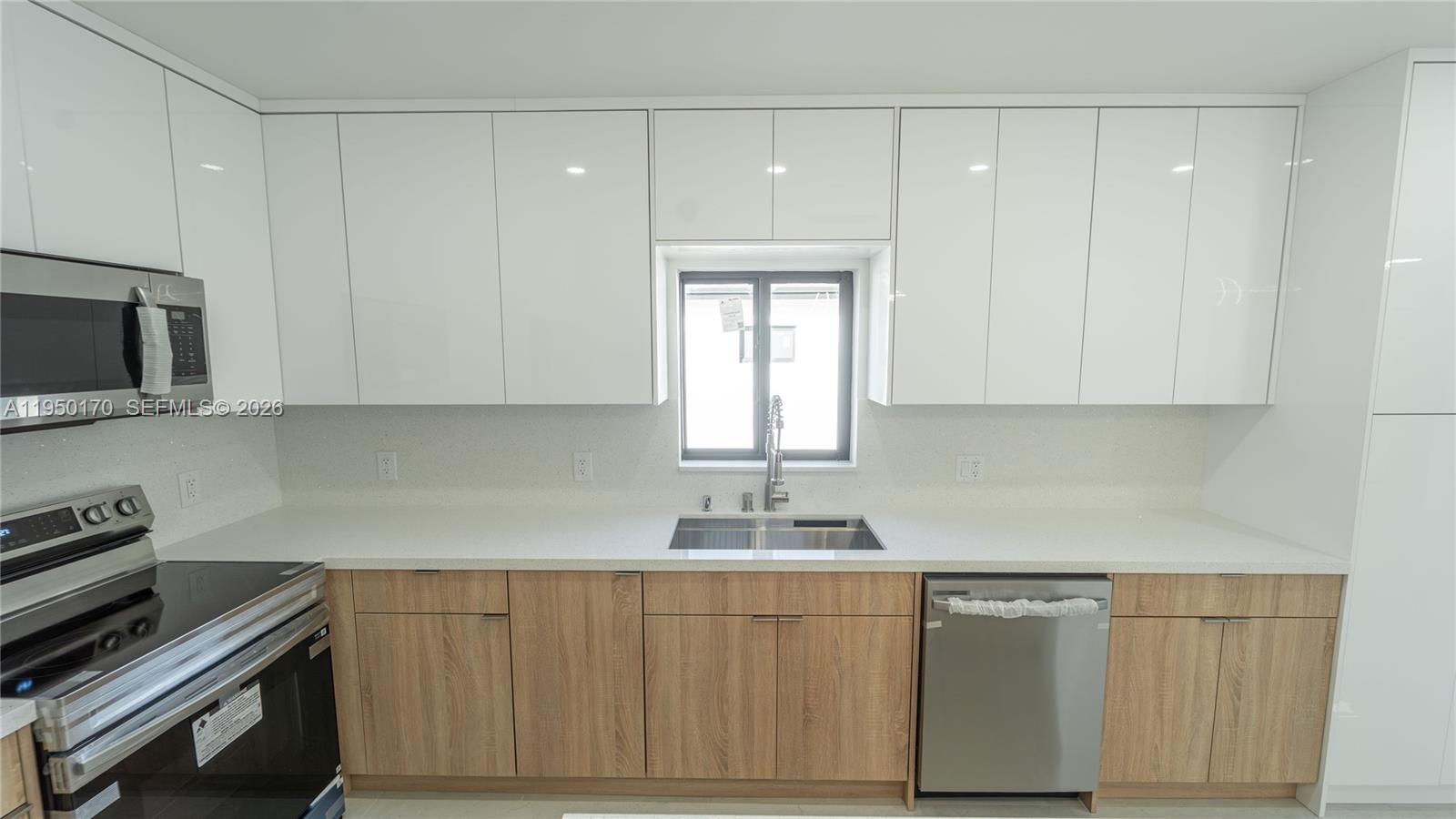 22840 Southwest 122nd Place Miami, FL 33170 - Photo 17 of 36 a kitchen with granite countertop white cabinets and stainless steel appliances