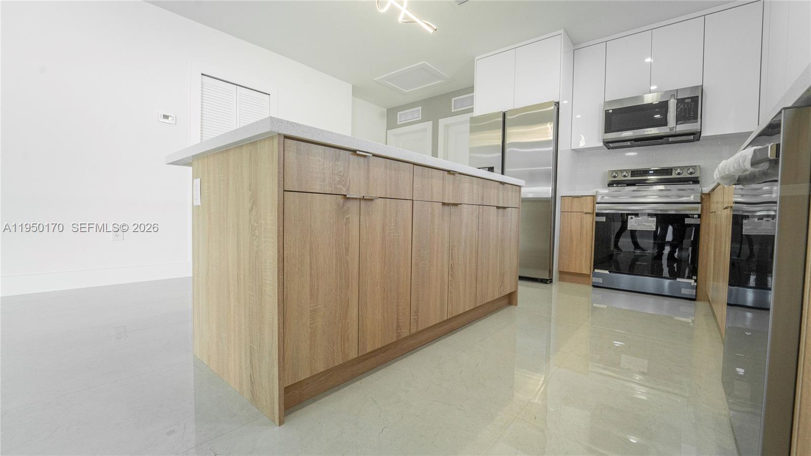 22840 Southwest 122nd Place Miami, FL 33170 - Photo 19 of 36 a view of kitchen and microwave