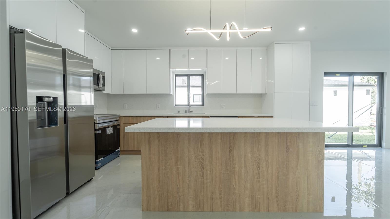 22840 Southwest 122nd Place Miami, FL 33170 - Photo 20 of 36 a kitchen with kitchen island a counter space a sink stainless steel appliances and windows