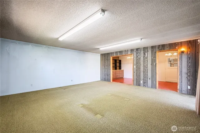 an empty room with an empty space and windows