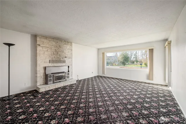 a view of a bedroom with furniture and window