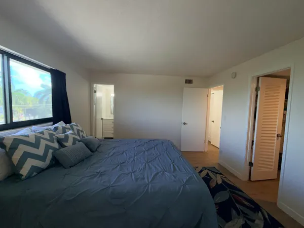 a bedroom with bed and a flat screen tv