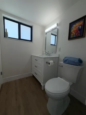 a bathroom with a toilet a sink and mirror