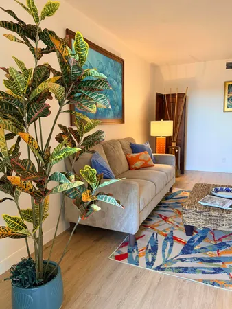 a living room with furniture and a potted plant