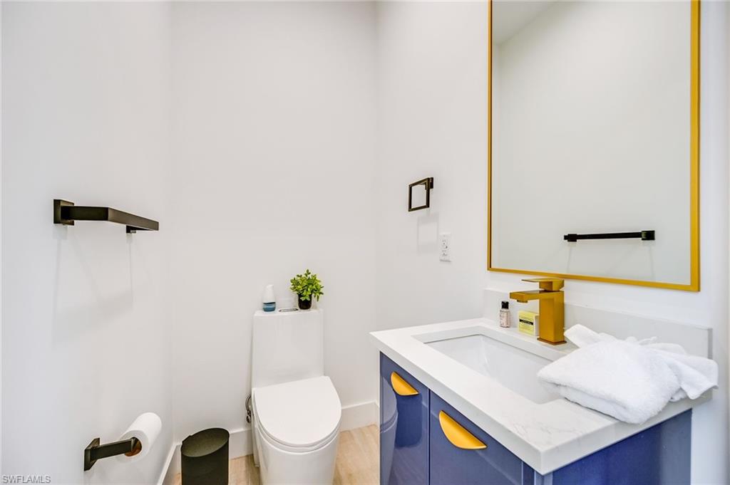 3400 Canal Street Naples, FL 34112 - Photo 12 of 34 a bathroom with a sink a toilet and a mirror