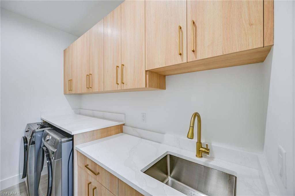 3400 Canal Street Naples, FL 34112 - Photo 13 of 34 a kitchen with a sink cabinets and appliances