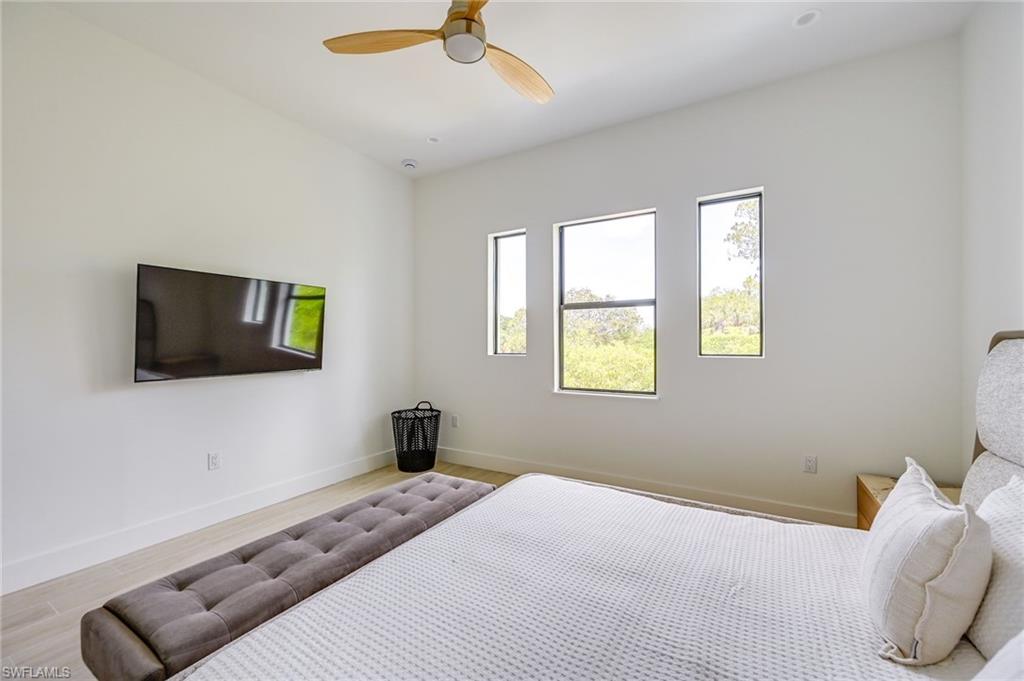 3400 Canal Street Naples, FL 34112 - Photo 20 of 34 a bedroom with a bed and a flat screen tv