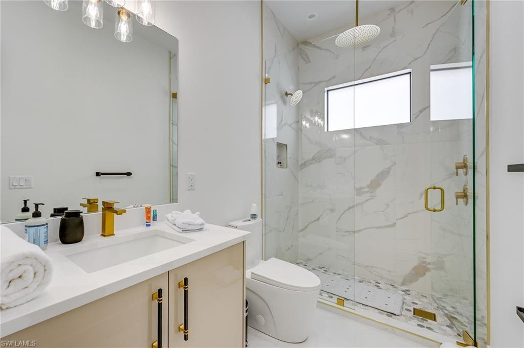 3400 Canal Street Naples, FL 34112 - Photo 21 of 34 a bathroom with a sink a toilet and shower