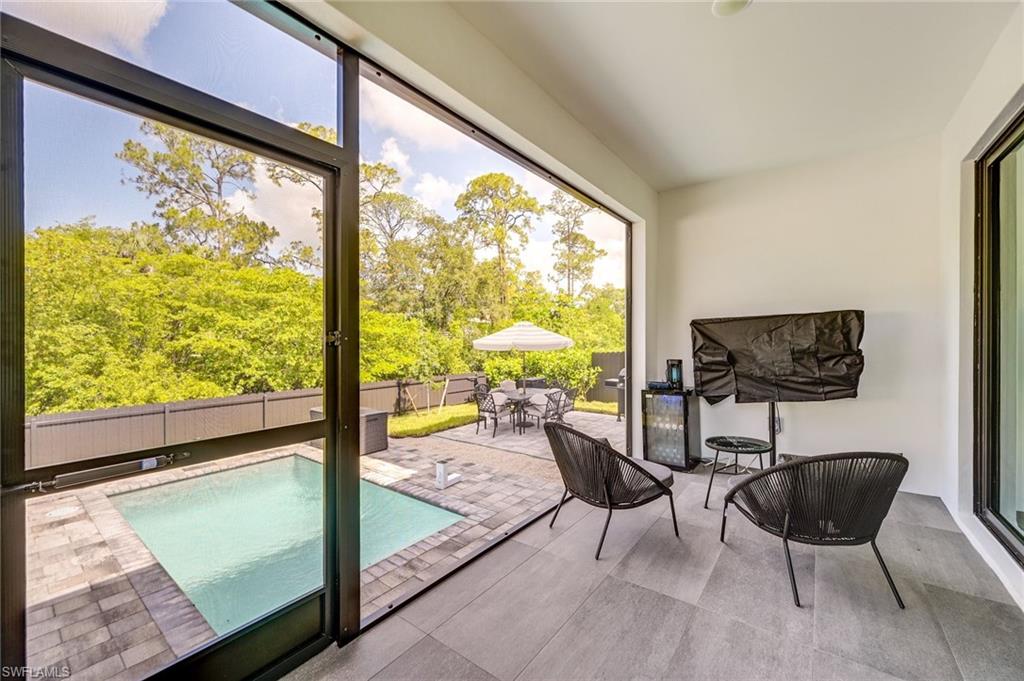 3400 Canal Street Naples, FL 34112 - Photo 29 of 34 a living room with furniture and a large window