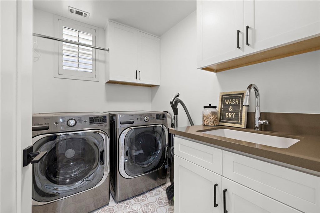 7 Bluewing Lane Ladera Ranch, CA 92694 - Photo 24 of 55 a utility room with sink dryer and washer