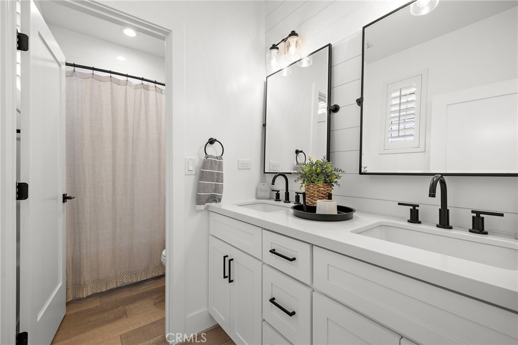 7 Bluewing Lane Ladera Ranch, CA 92694 - Photo 27 of 55 a bathroom with a double vanity sink and a mirror