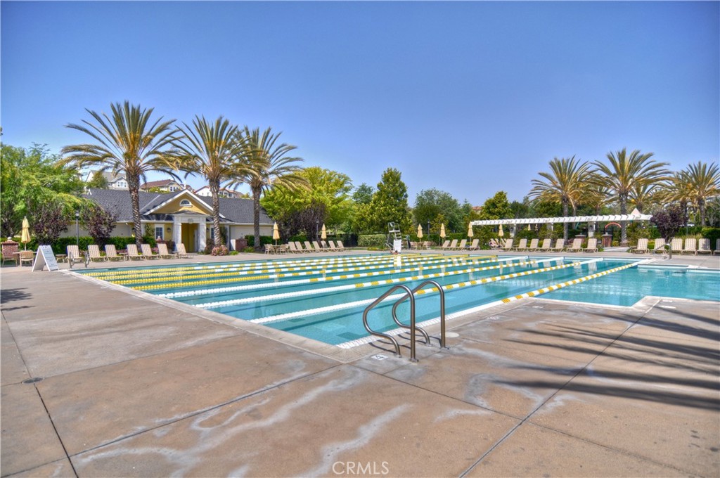 7 Bluewing Lane Ladera Ranch, CA 92694 - Photo 44 of 55 a view of a swimming pool with a lawn chairs next to a road