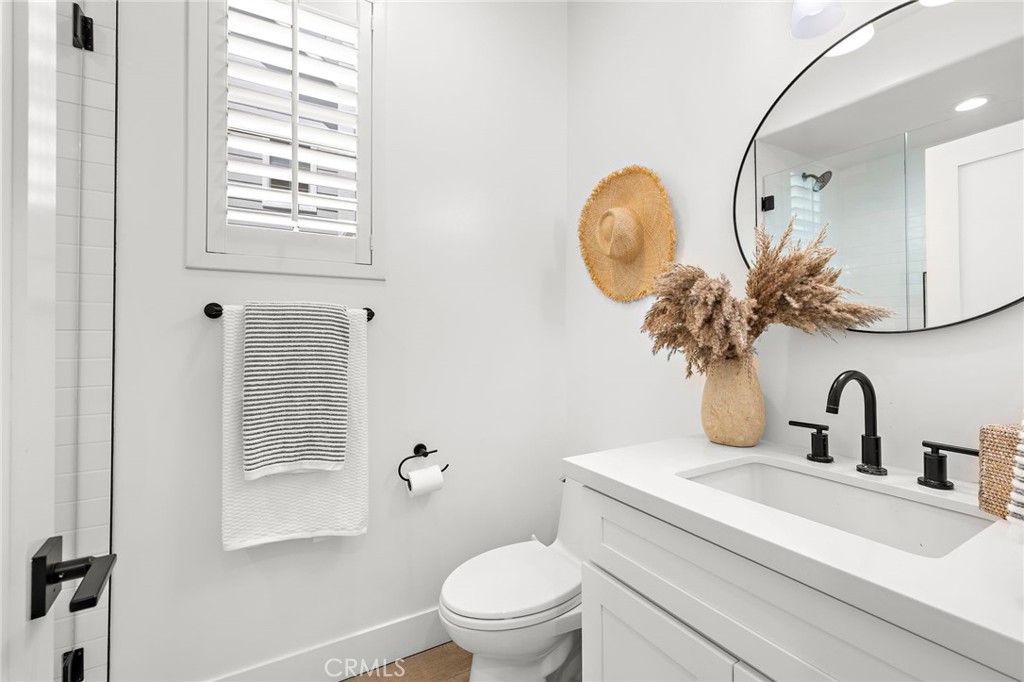 7 Bluewing Lane Ladera Ranch, CA 92694 - Photo 6 of 55 a bathroom with a toilet a sink and mirror