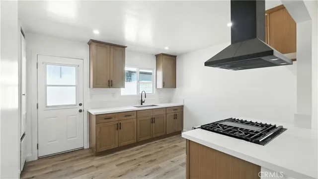 a kitchen with stainless steel appliances a sink stove and cabinets