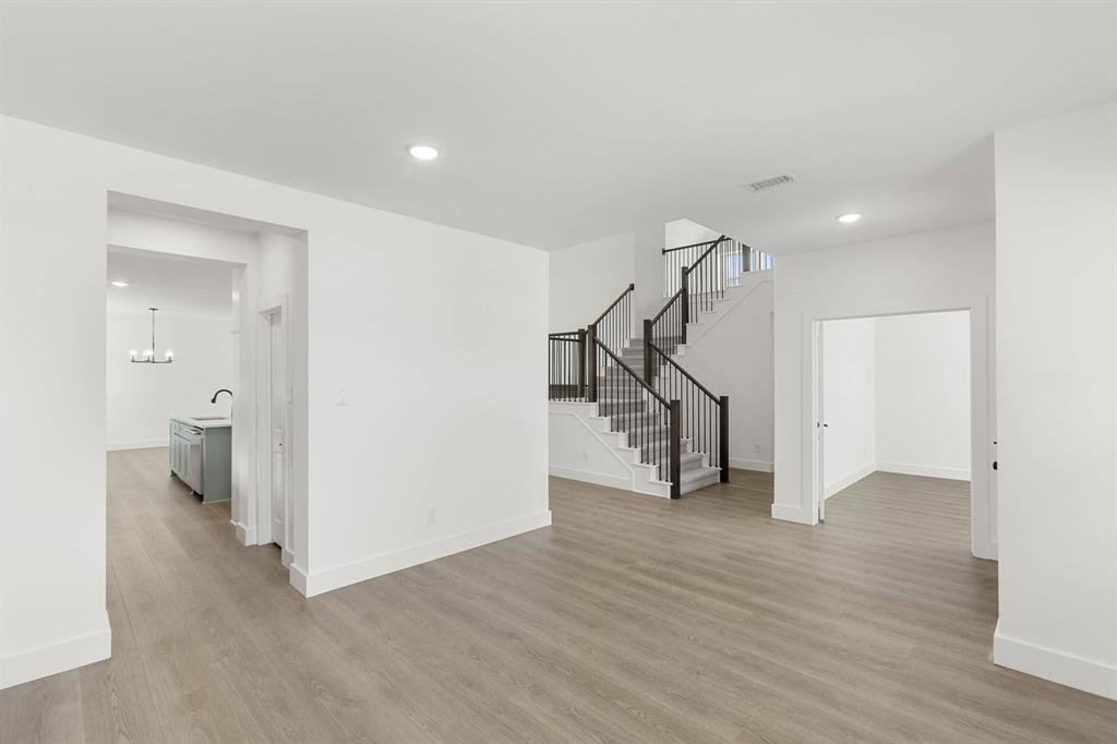 413 Tower Street DeSoto, TX 75115 - Photo 8 of 30 a view of a hallway with wooden floor and entryway