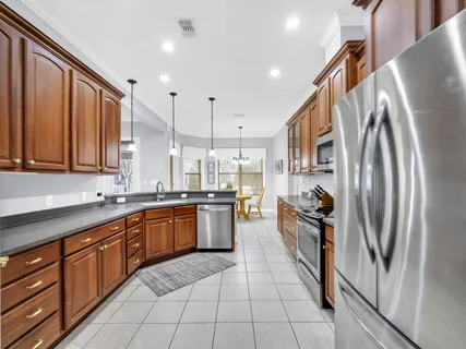 a view of a dining room with furniture and chandelier