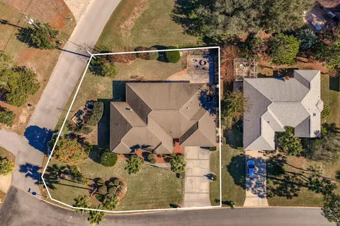 an aerial view of a house with a yard and fountain