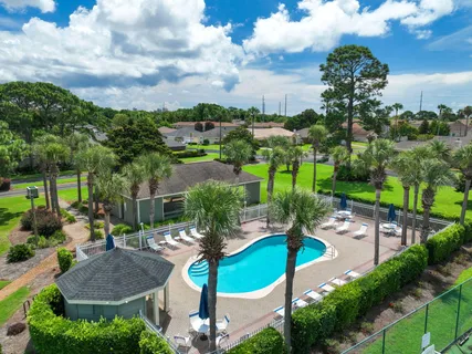 a view of swimming pool with outdoor seating and trees