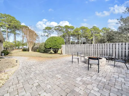 a view of a porch with furniture and a yard