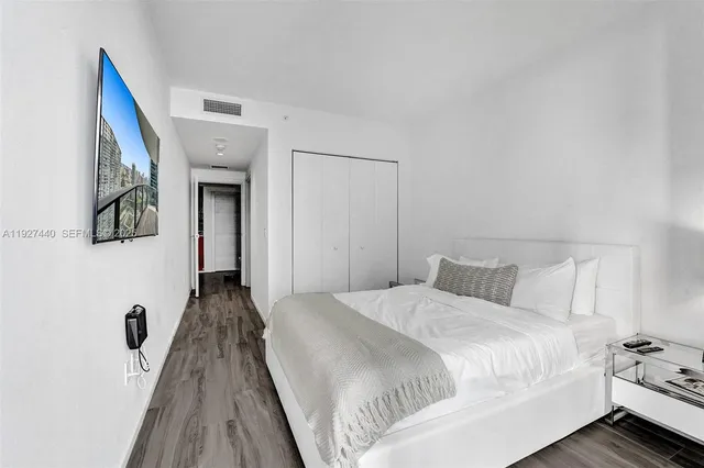 a bed room with a bed and a potted plant