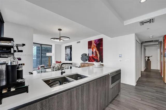 a living room with kitchen island furniture and wooden floor