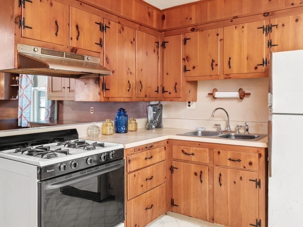 2 Collier Road Scituate, MA 02066 - Photo 21 of 41 a kitchen with granite countertop a sink stove and cabinets