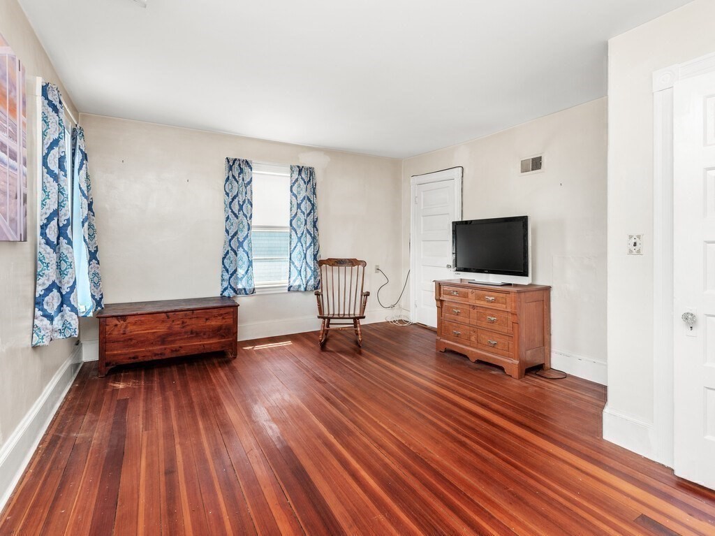 2 Collier Road Scituate, MA 02066 - Photo 28 of 41 a room with furniture and a wooden floor