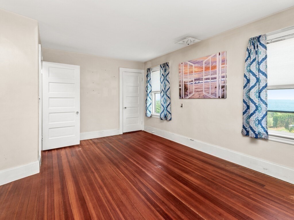 2 Collier Road Scituate, MA 02066 - Photo 29 of 41 a view of an empty room with wooden floor and a window