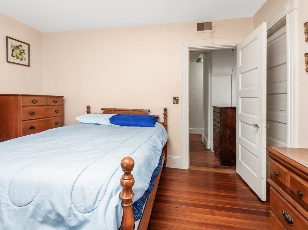 2 Collier Road Scituate, MA 02066 - Photo 31 of 41 a bedroom with a bed and wooden floor