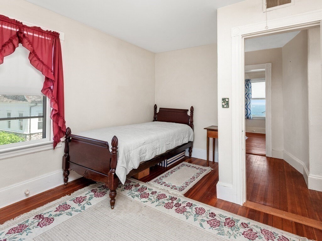 2 Collier Road Scituate, MA 02066 - Photo 34 of 41 a bedroom with a bed and wooden floor