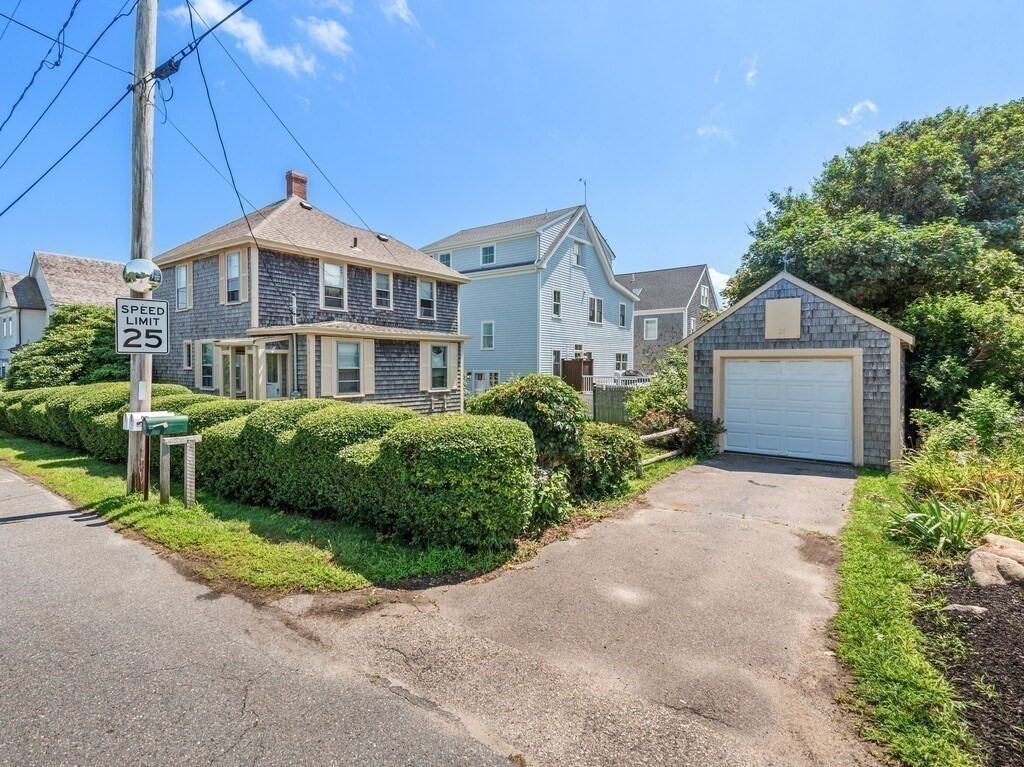 2 Collier Road Scituate, MA 02066 - Photo 10 of 41 a front view of a house with a garden and plants